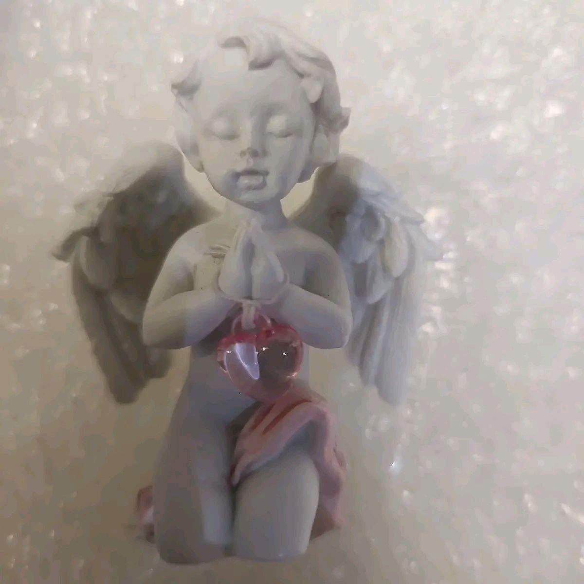 Cherub with pink crystal heart