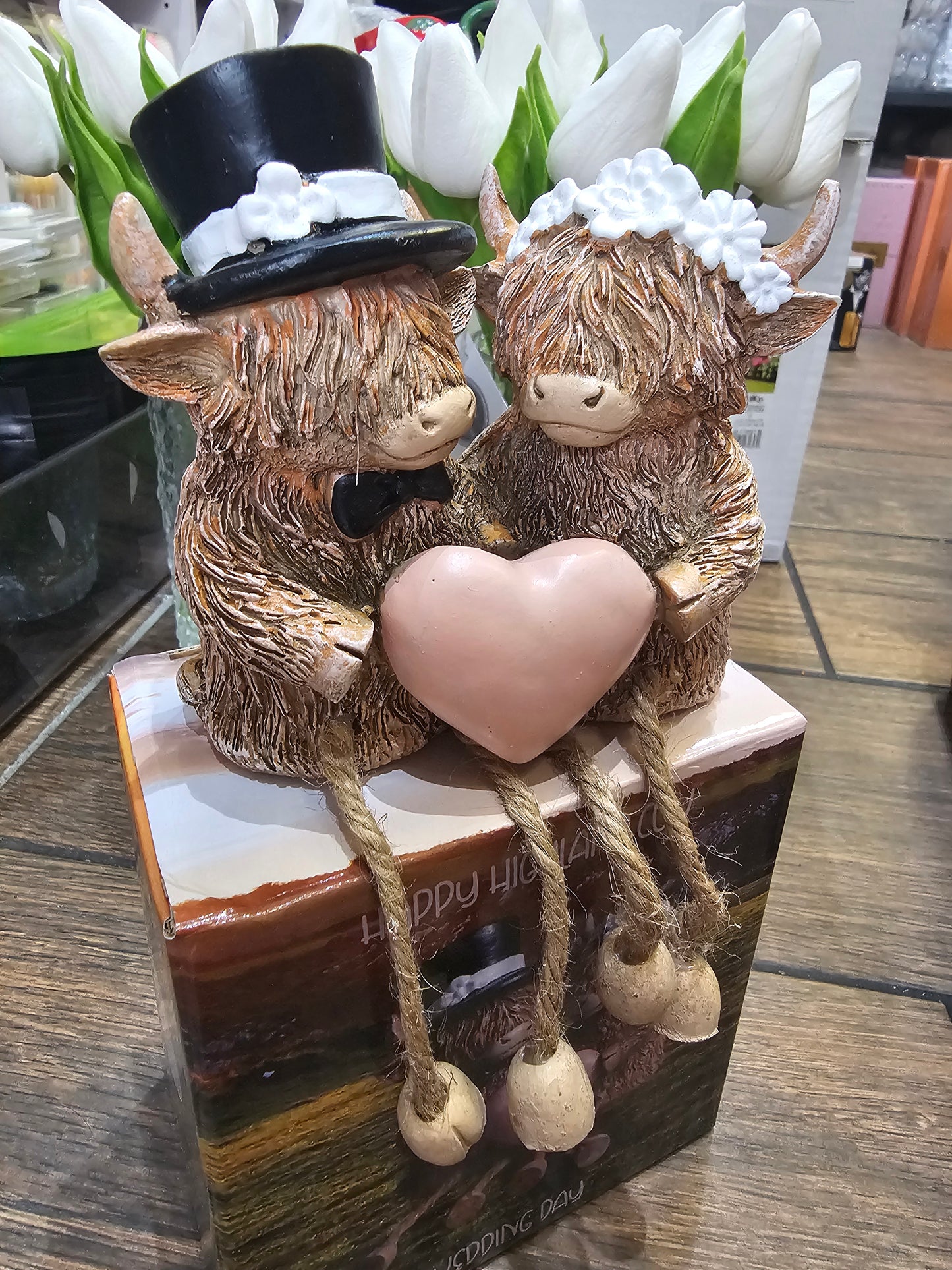 Happy Highland Cow Wedding Day statue with dangling legs