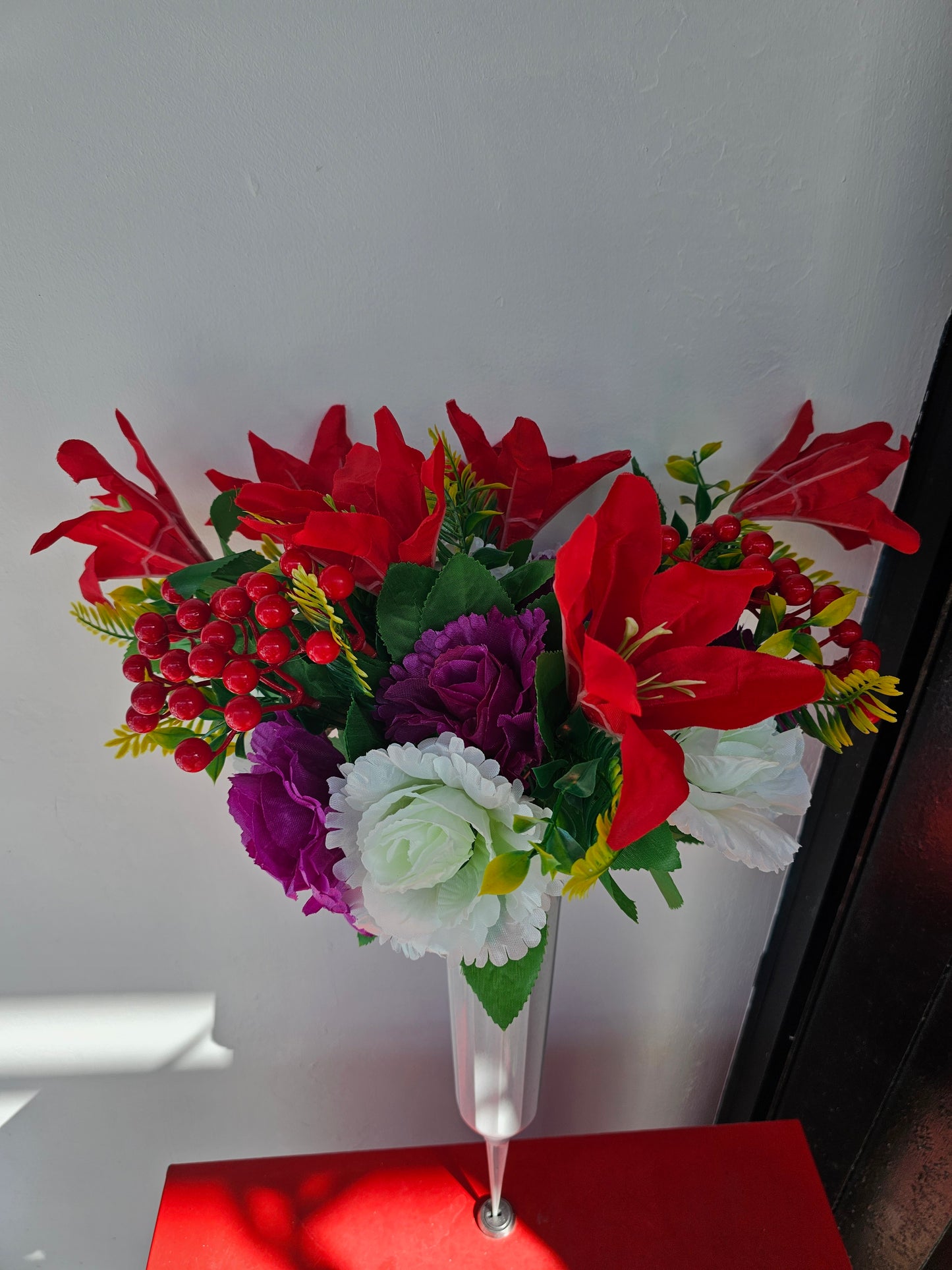 Artificial flower bouquet in vase with ground stake