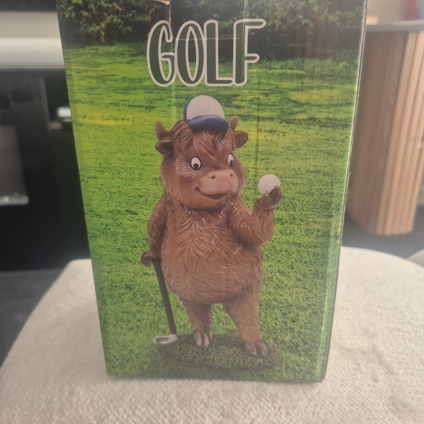 Golfing Highland cow