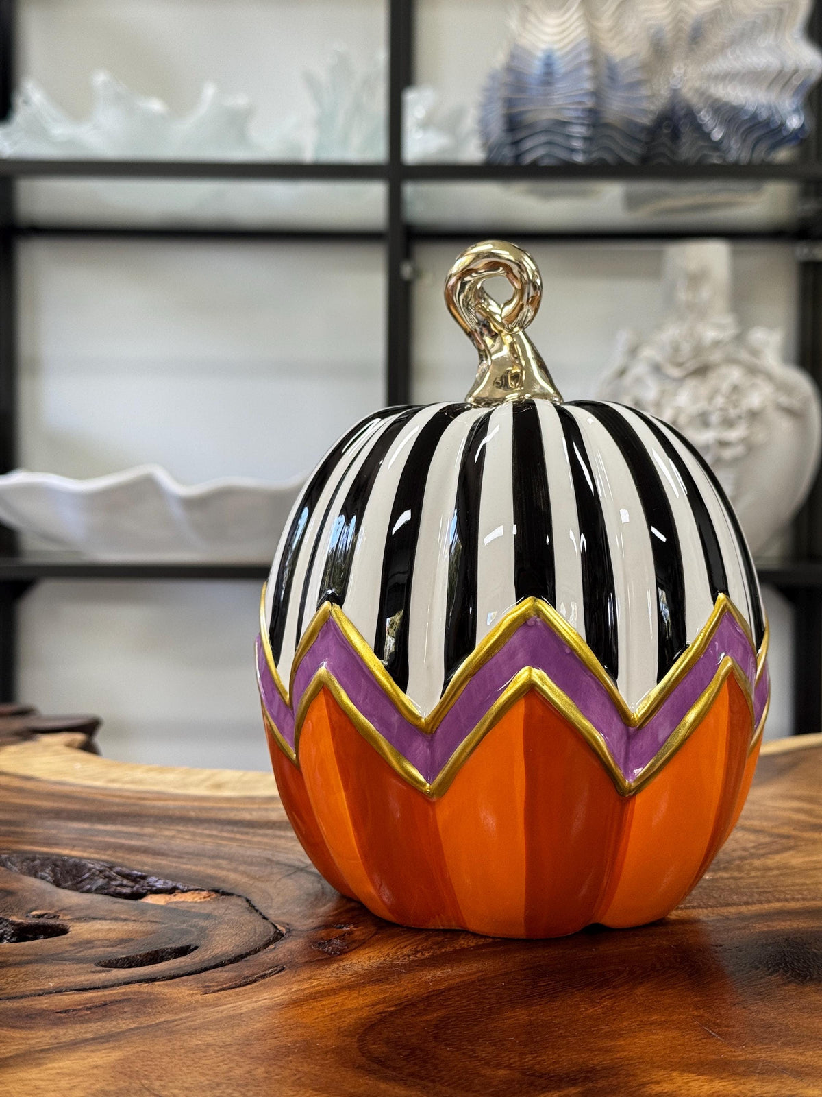 Decorative ceramic Halloween pumpkin featuring a distinct hand-painted seasonal design