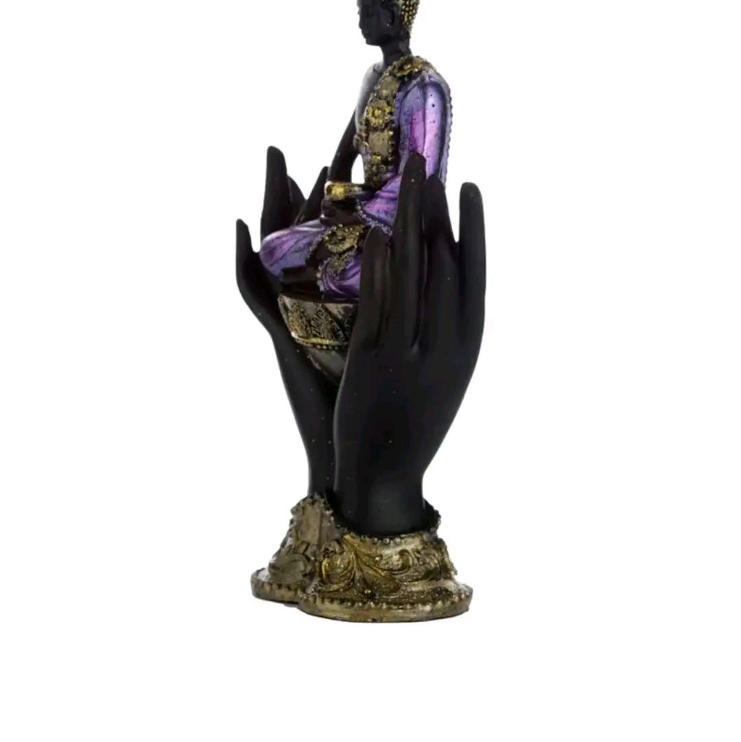 purple and gold black thai buddah sitting in hands