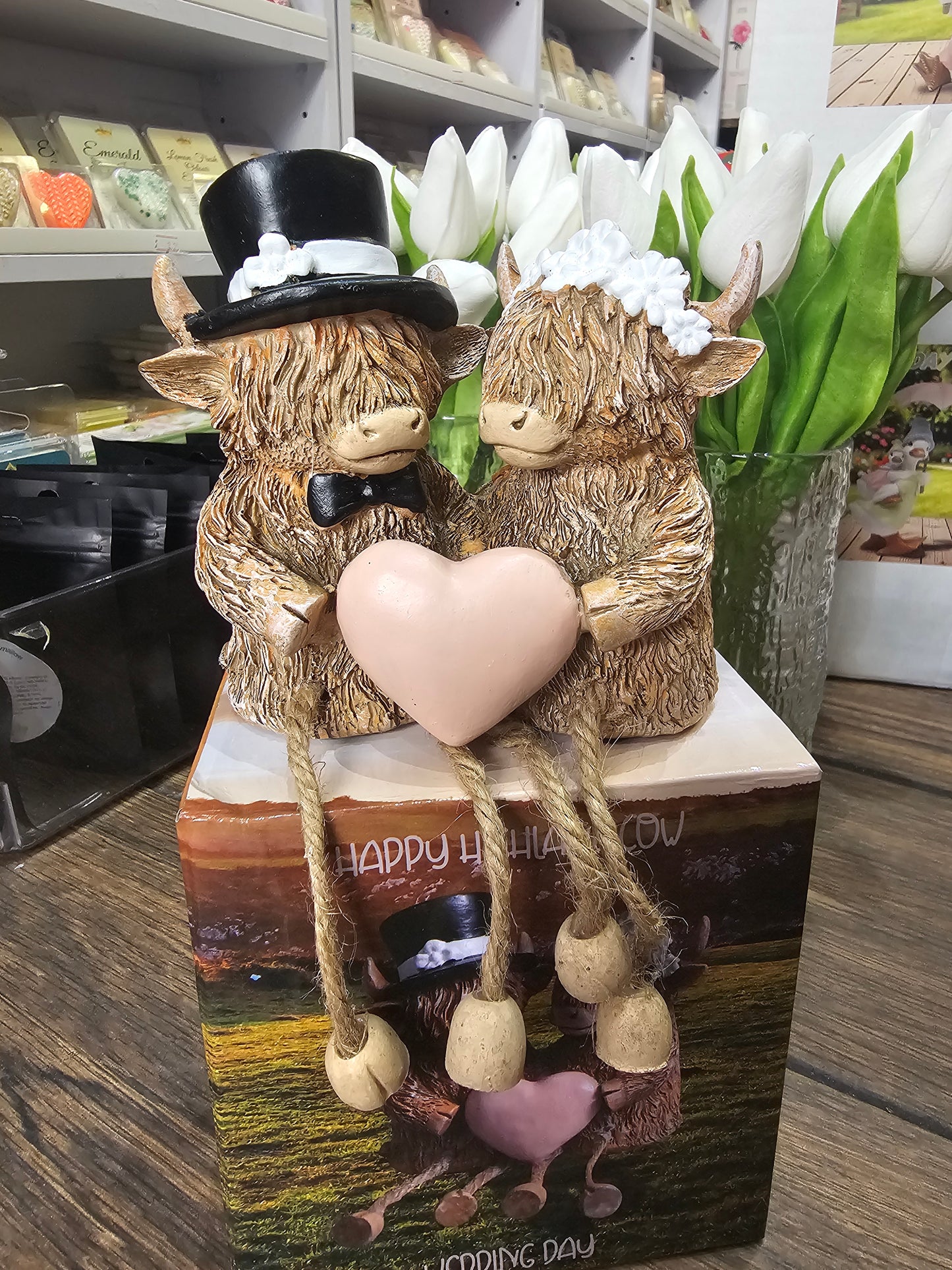 Happy Highland Cow Wedding Day statue with dangling legs