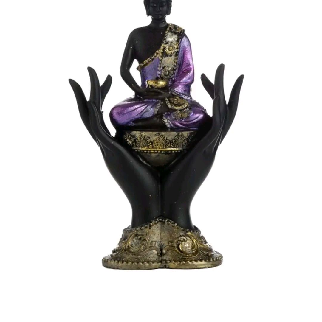 purple and gold black thai buddah sitting in hands