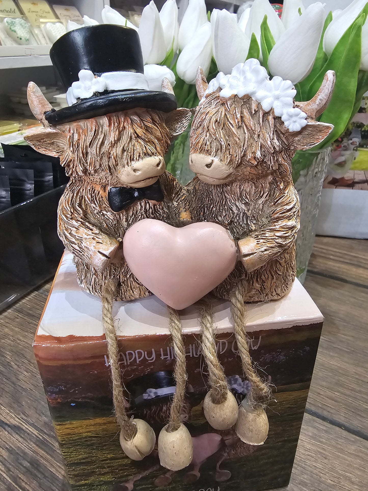 Happy Highland Cow Wedding Day statue with dangling legs