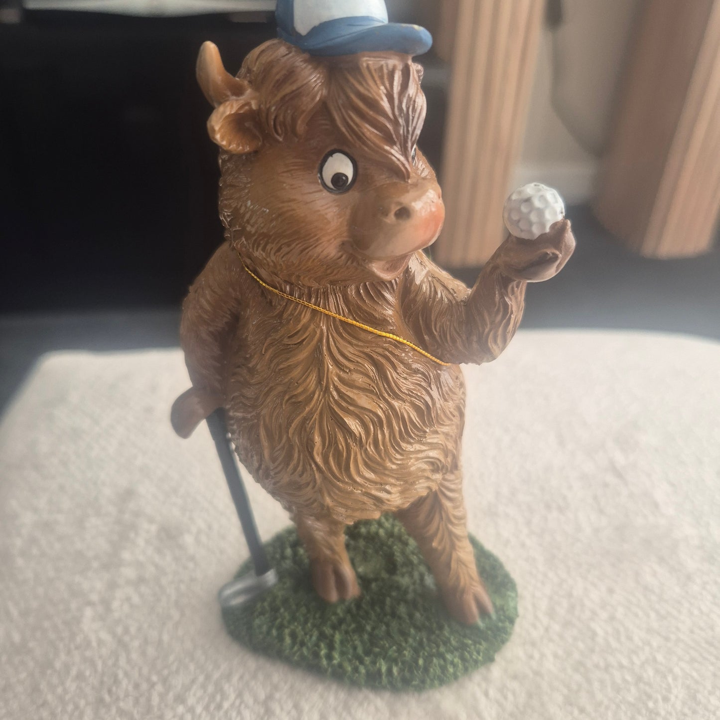 Golfing Highland cow