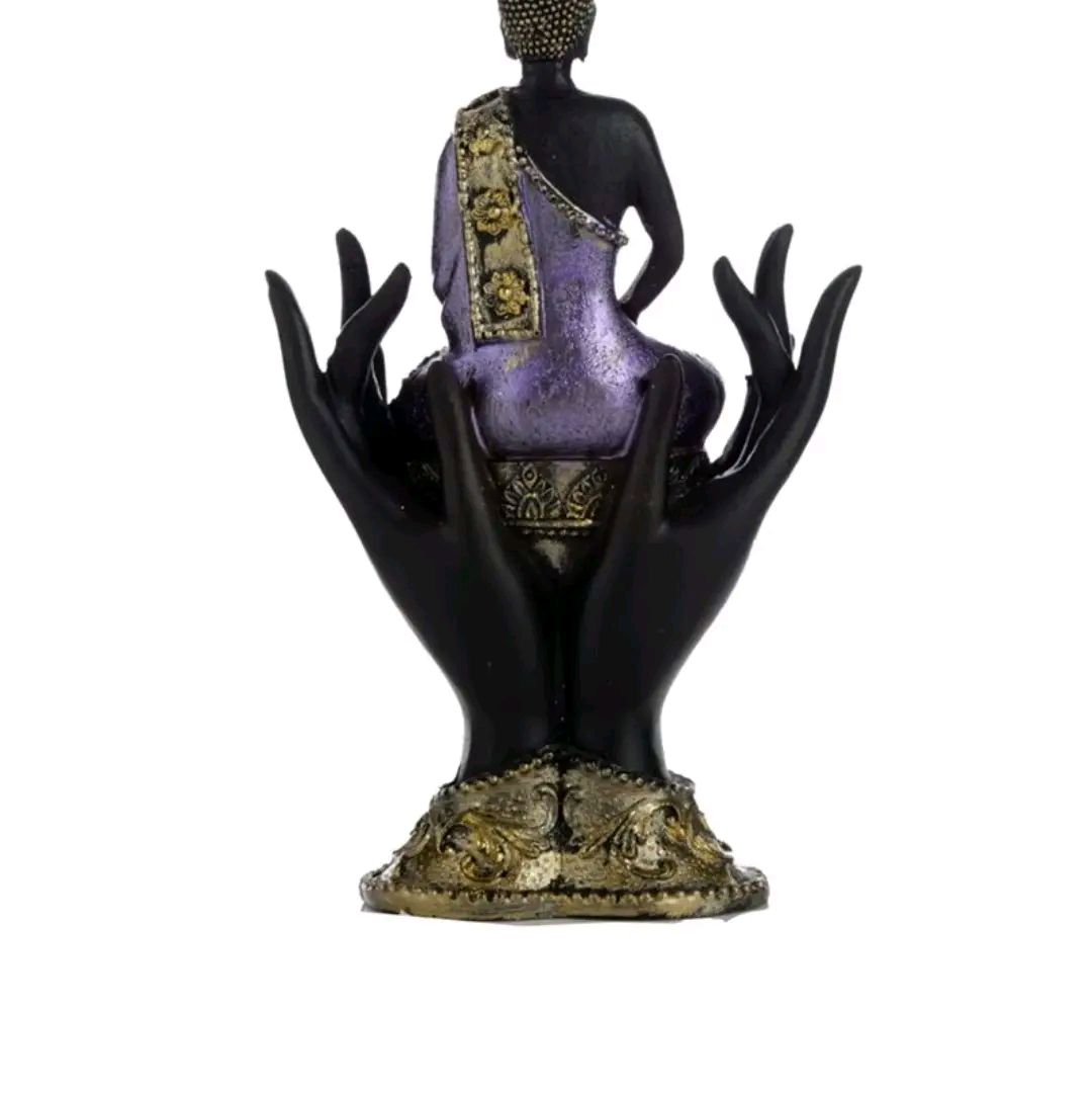 purple and gold black thai buddah sitting in hands