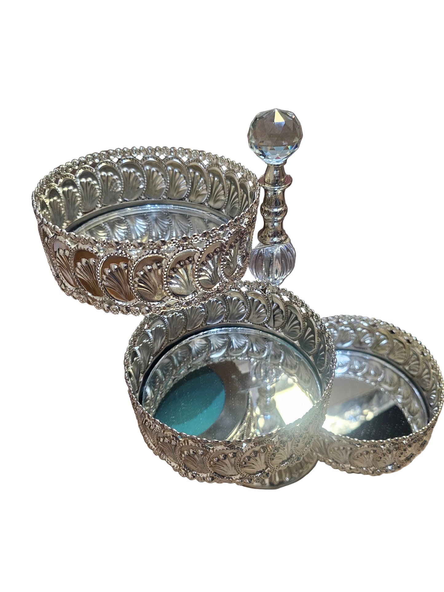 Silver-plated tiered metal cake or candy stand with a mirror top and shell detailing