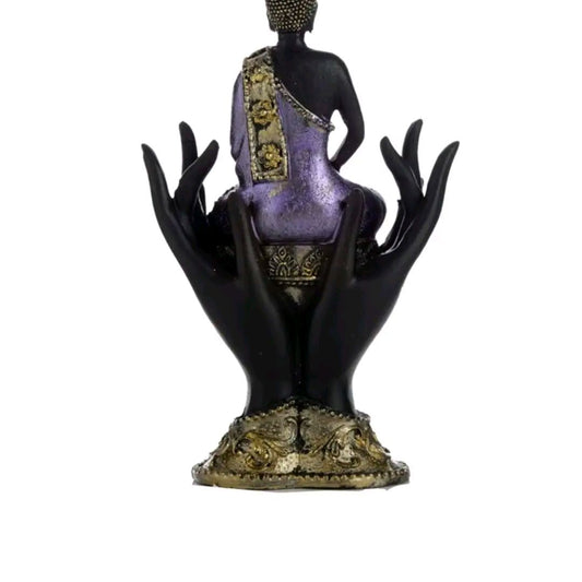 purple and gold black thai buddah sitting in hands