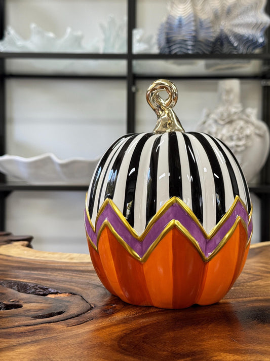 Decorative ceramic Halloween pumpkin featuring a distinct hand-painted seasonal design